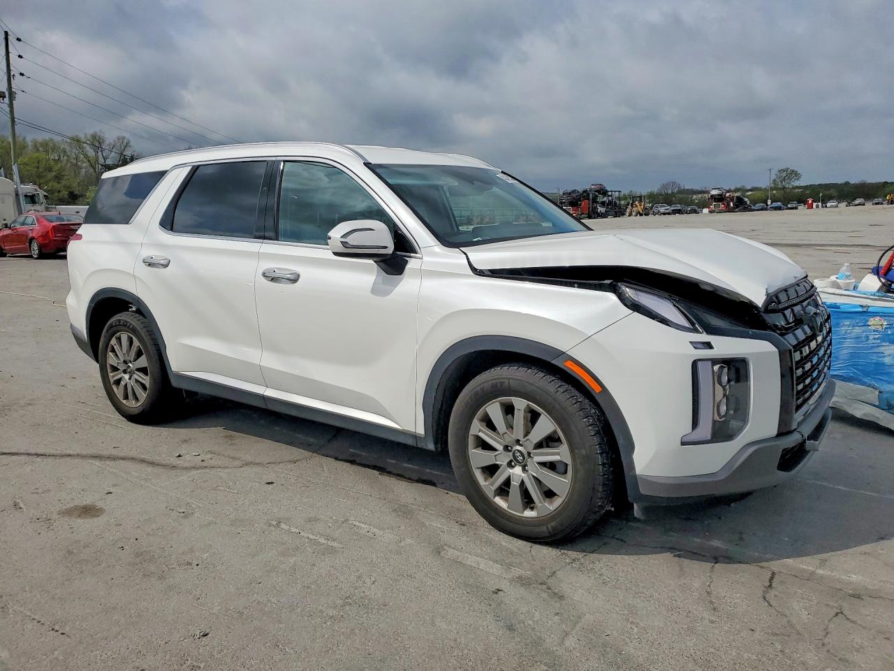 White SUV side view at auction yard